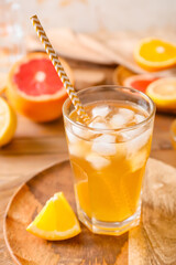Glass of tasty ice tea on wooden background