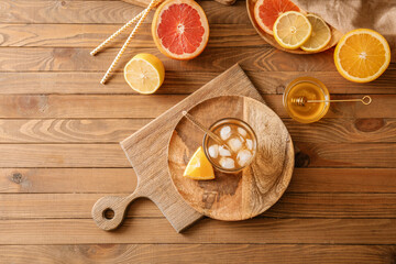Glass of tasty ice tea on wooden background