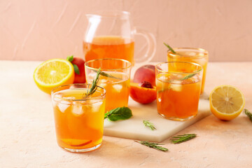 Glasses of tasty ice tea on light background