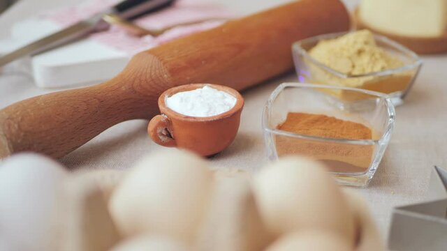 Put on a plane the ingredients: Flour, eggs, sugar, butter, honey, baking powder, spices ginger. Step by step. Products on the table for making sugar ginger cookie dough to bake Christmas cookies.