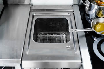 Stainless steel deep fryer machine in professional kitchen