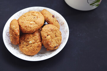 Homemade oatmeal cookies on black background.
