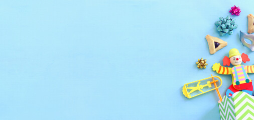 Purim celebration concept (jewish carnival holiday) over wooden blue background. Top view, flat lay