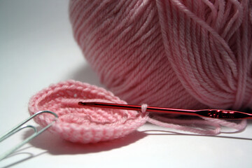 Balls of yarn in different colors and a crochet hook.
