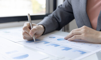 Financial businesswomen analyze the graph of the company's performance to create profits and growth, Market research reports and income statistics, Financial and Accounting concept.