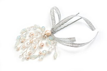 A hair clip on a hairpin in the form of a twig made of silver wire, decorated with river pearls and crystal.