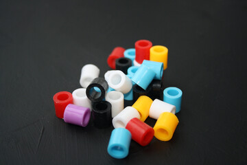 Colorful beads on a black background.