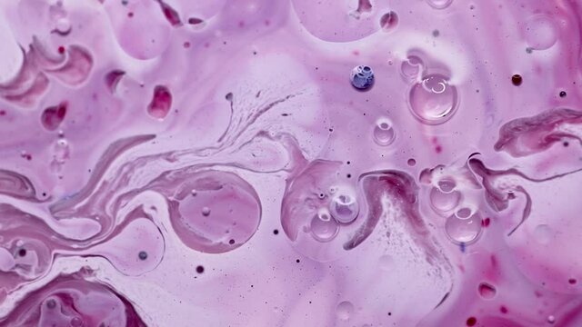 Colorful water drops on pinkk background