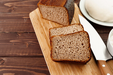 Sliced rye bread on brown wooden background