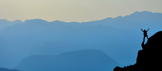 silhouette of a person on a mountain top