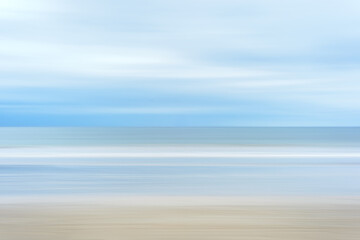 Blurred Beach Stripes in natural neutral tones of soft blue and beige create a calm relaxed background - horizontal