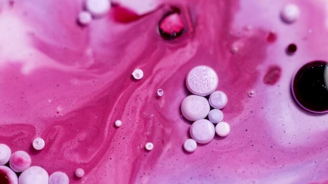 Colorful cirkles on pink bakground, ink liquid macro art design
