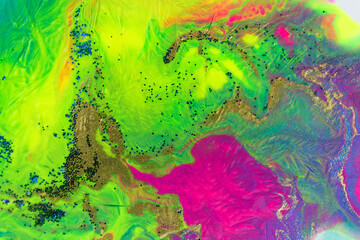 Neon colored marble pattern with golden glitter. Fluorescent liquid background. Artwork abstract bright texture.