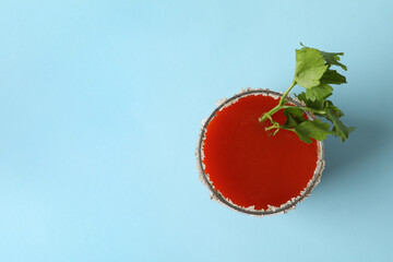 Glass of Bloody Mary on blue background