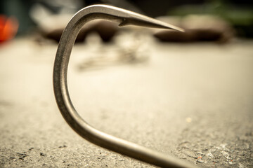 Fishing hooks on concrete textured background macro