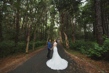Walking the young bride and groom in the woods