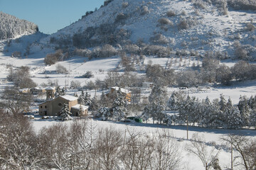 Panoramic view of little mountain village covered by snow in Umbria