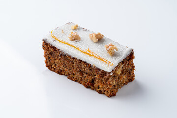 Carrot cake pastry with sugar coat and nuts on top,?white background with soft shadow