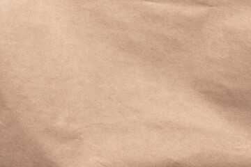 Texture of crumpled light brown craft paper.
