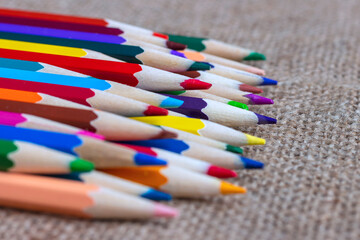 Set of colorful pencils on burlap.