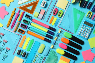 Different stationery on light blue background, flat lay. Back to school