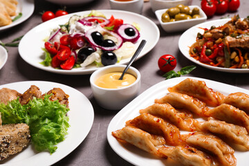 Buffet service. Many different dishes on grey table