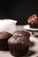Delicious chocolate muffins on plate, closeup view