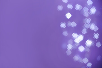 Beautiful snowflake shaped lights on purple background, space for text