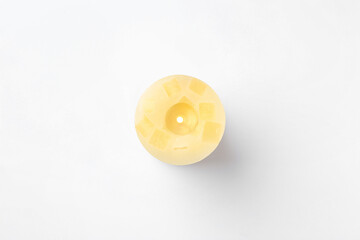 Obraz premium Yellow candle isolated on white, top view