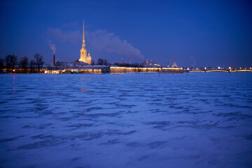 Fototapeta premium Evening view of illuminated Peter and Paul Fortress on a winter evening. Winter in St. Petersburg, Russia.