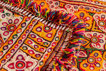 Mirrored embroidery work typical of the Aahir tribe,unidentified man embroidering cloth in...