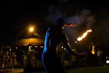 Fototapeta na wymiar Firestarter performing amazing fire show