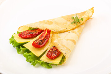 Pancake with cheese and dry tomato