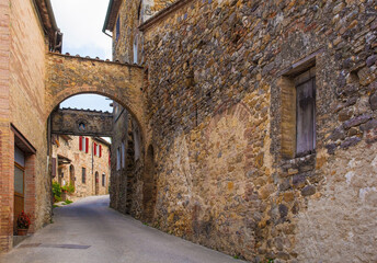 Fototapeta na wymiar The historic arched entrance to the medieval village of San Lorenzo a Merse near Monticiano in Siena Province, Tuscany, Italy 