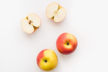 red apples on white background, halves of apples on a white background