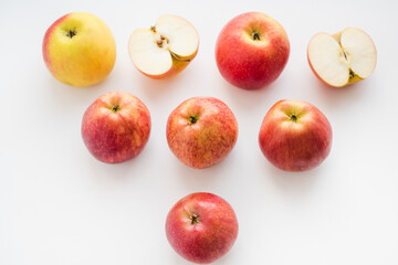 red apples on white background, halves of apples on a white background
