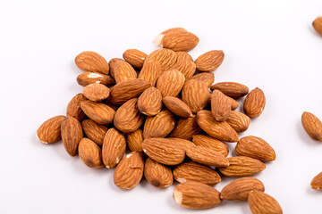 Almonds close up on a white background.