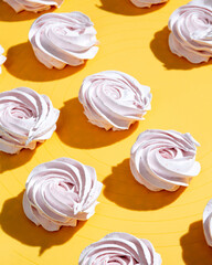 Pink marshmallow on a yellow background. Selective focus.