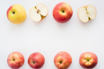 red apples on white background, halves of apples on a white background