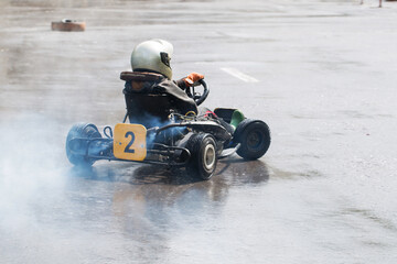 Karting - driver in helmet on kart circuit