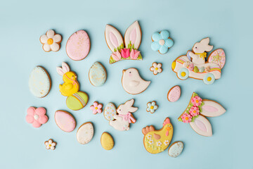 Set of Colorful easter cookies on blue wooden background, assortment sweet gifts, seasonal springtime holiday greeting card, creative idea for decor, event menu, funny cute food