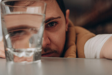 fashion portrait of a guy with a glass of water