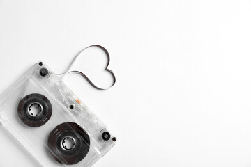 Music cassette and heart made with tape on white background, top view. Listening love song