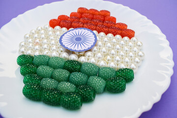 Jewelry beads ruby emerald colored represented Indian flag for Indian republic day celebration on 26 january. Beaded decoration colours of India