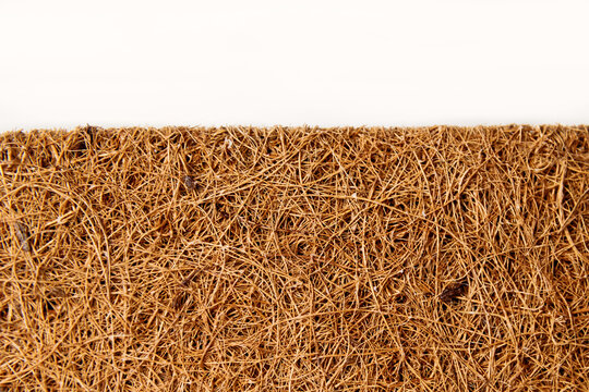 Close-up mattress made of coconut fiber isolated over white.