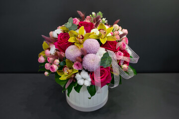Fresh flowers are collected in a bouquet. Hat box with flowers.