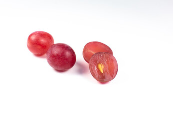 Purple ripe grapes cut in half on the white background. Close up photo. Ecological fruit for vegans. Vitamins.