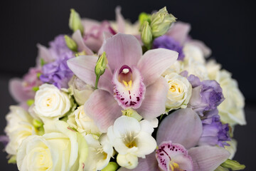 Fresh flowers are collected in a bouquet. A hatbox with flowers in lilac color.