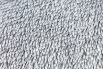 Grey cotton towel or carpet.fluffy texture background. Close up photo.