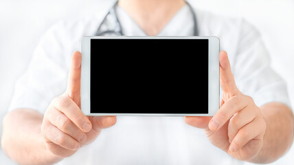 Tablet in doctor's hands on white background